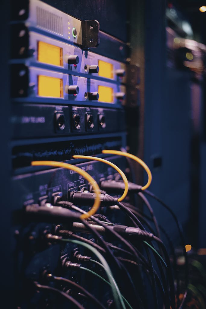 Close-up of network cables and ports in a server rack, showcasing connectivity.