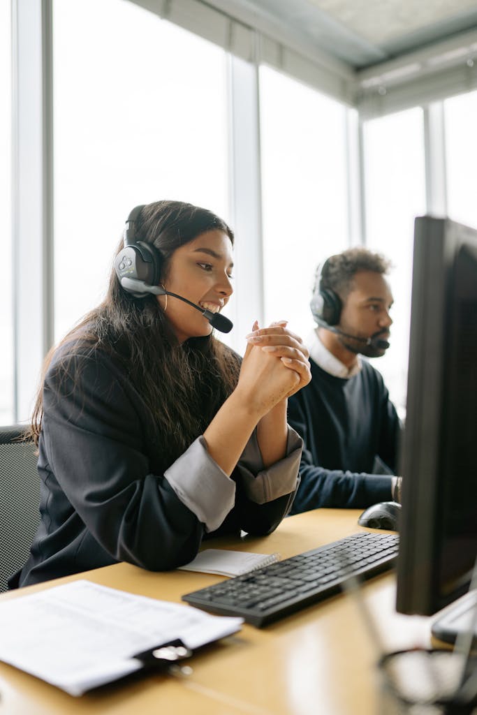 Customer service team working in a modern office with headsets.